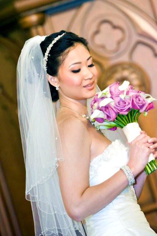 Bride stares at bouquet of pink and white flowers
