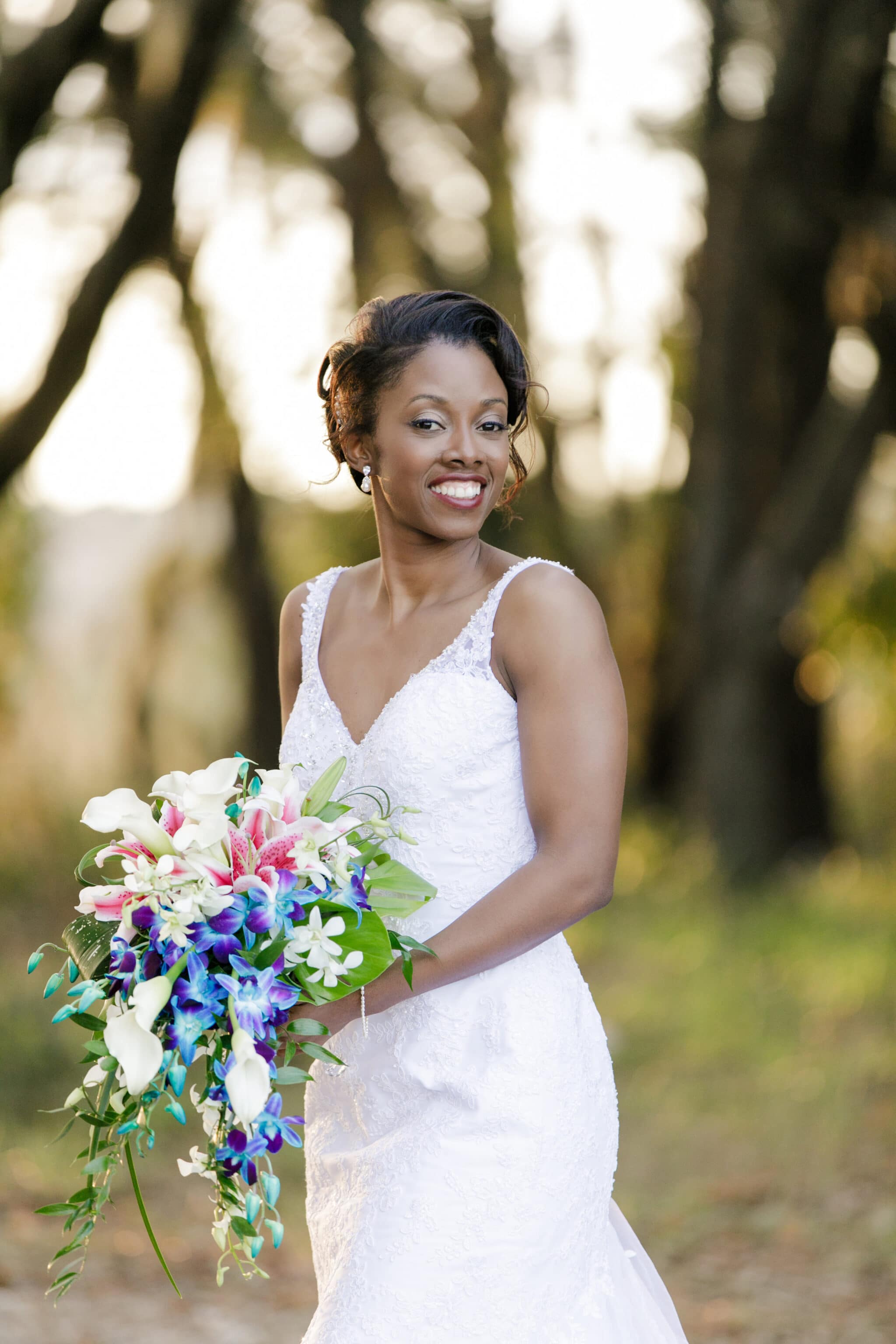 Bride posing with brightly colored bouquet
