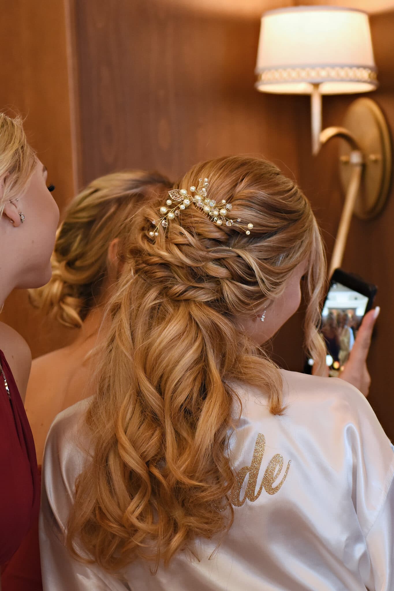 Rear view of bride taking a selfie with bridesmaids
