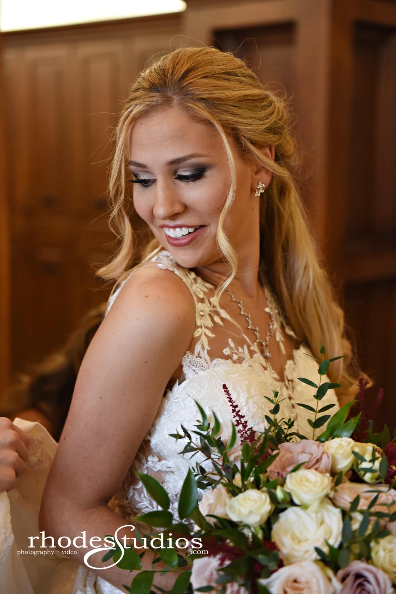 Bride smiling with her bouquet