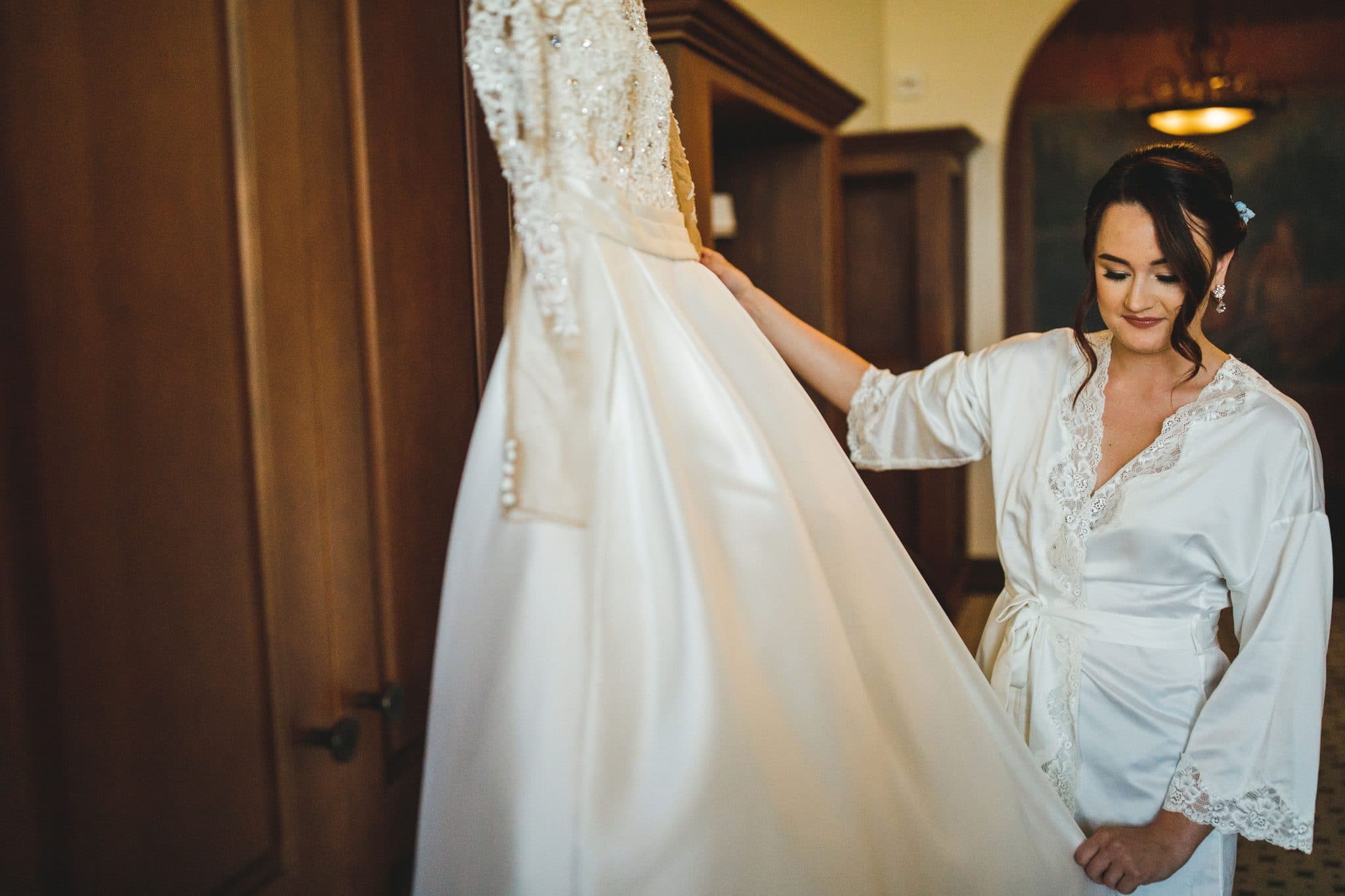 A bride admires her wedding dress.
