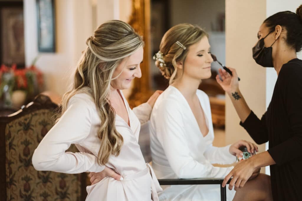 Bride having her makeup done on her wedding day.