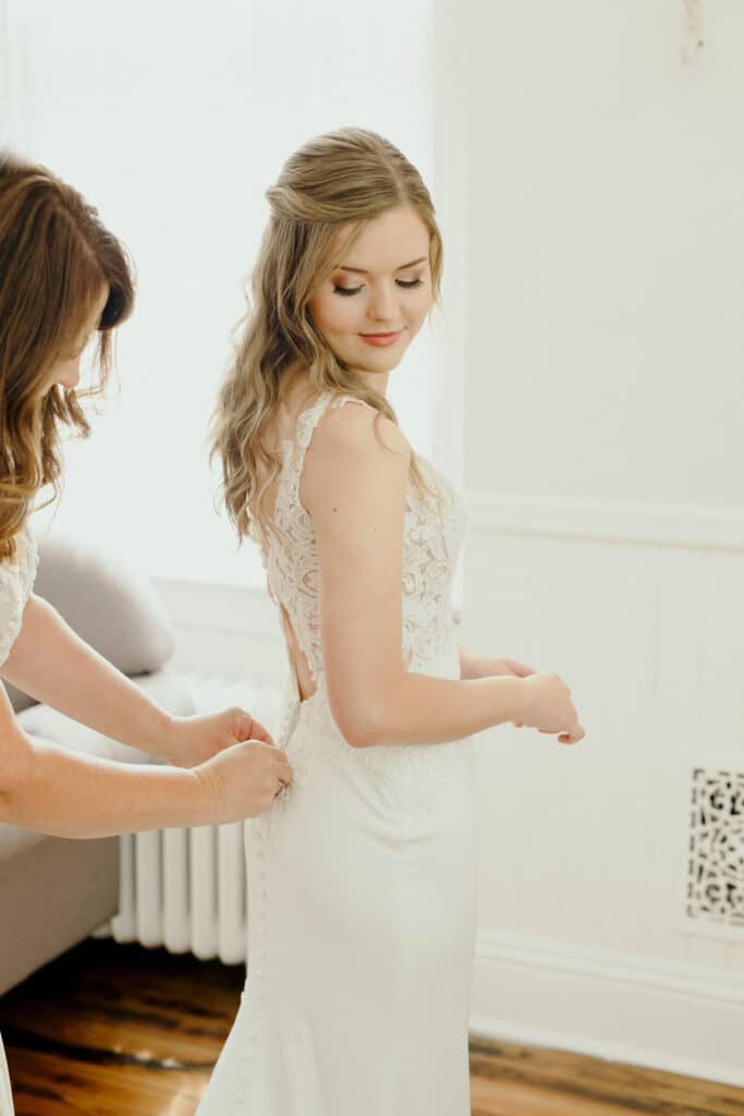 A bride getting into her wedding dress.