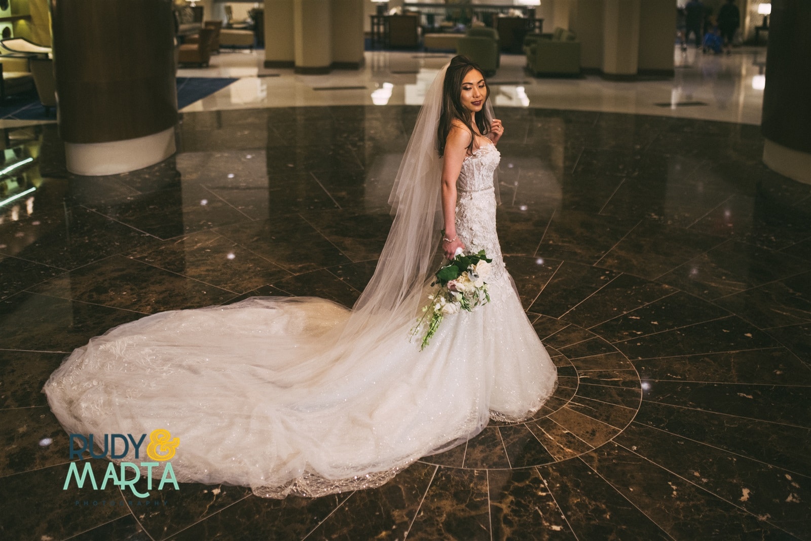 Bride posing in grand lobby